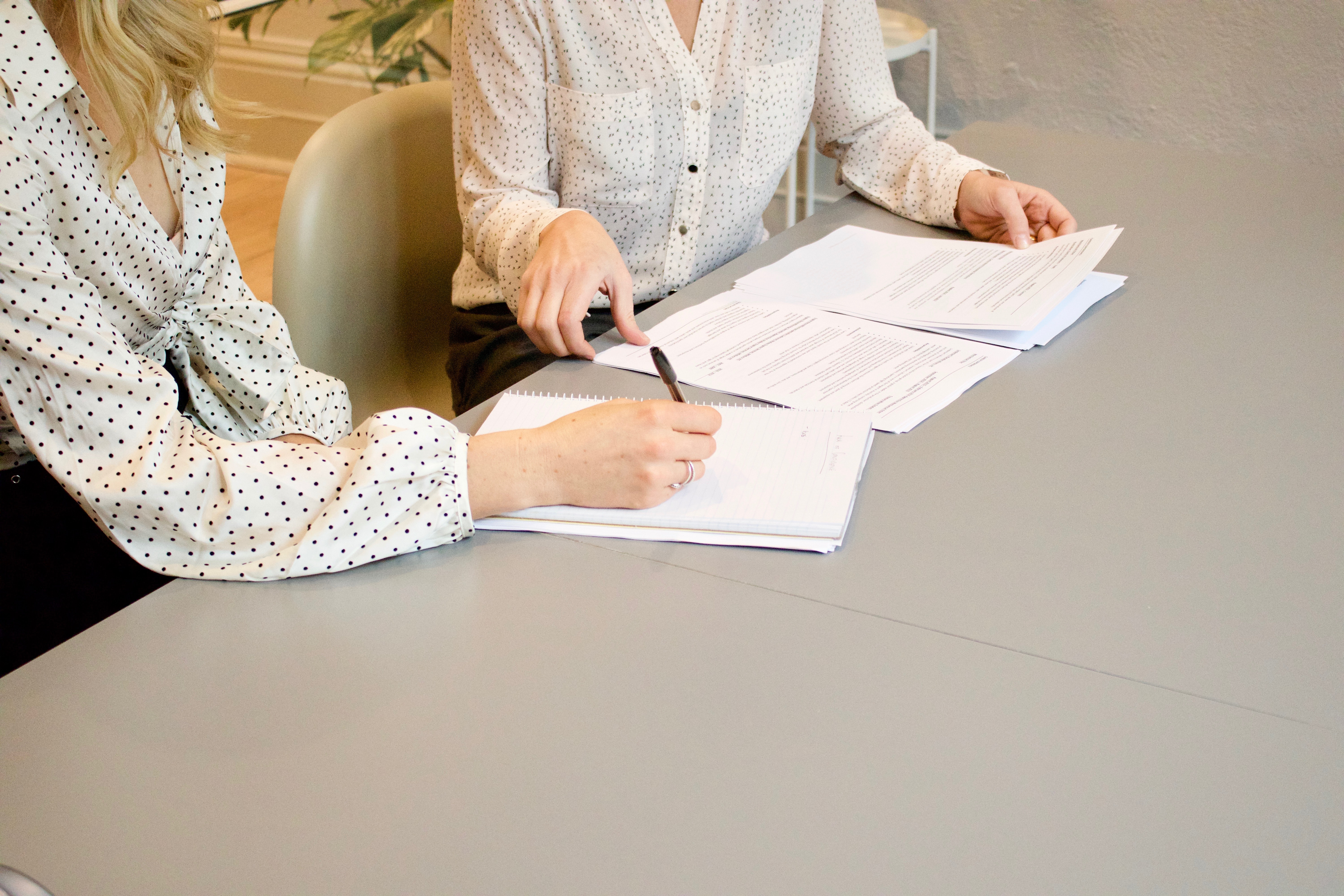 two people signing an agreement